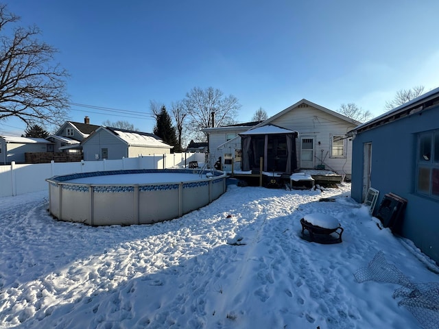 yard layered in snow featuring a fenced in pool