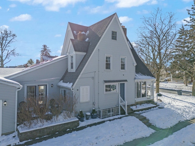 view of snow covered exterior with covered porch