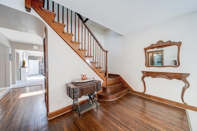 stairway with hardwood / wood-style flooring