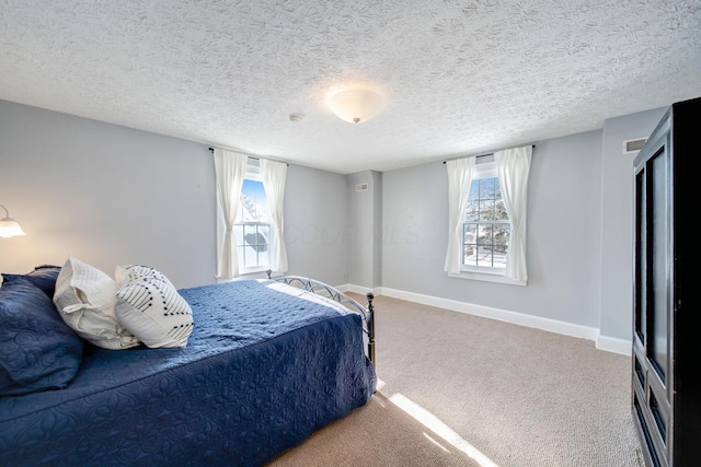 bedroom with a textured ceiling and carpet