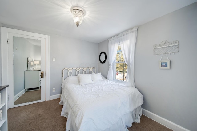 bedroom featuring dark carpet