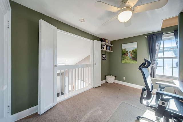 workout room featuring ceiling fan and carpet