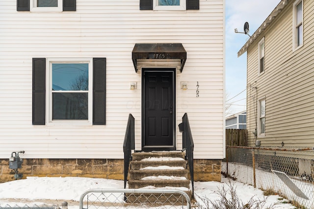 view of snow covered property entrance