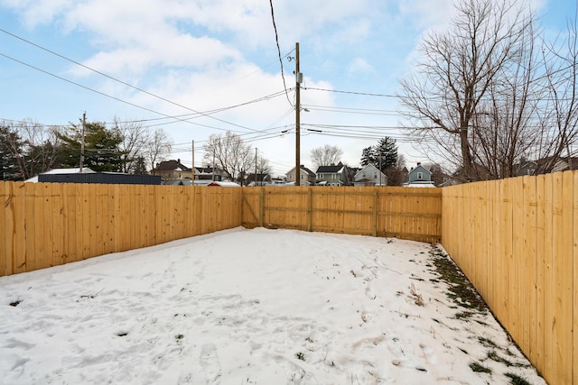 view of yard layered in snow