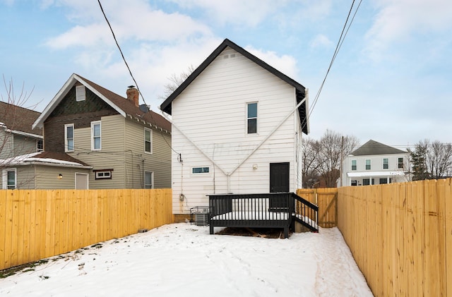 snow covered property featuring a wooden deck and central air condition unit