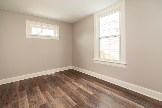 unfurnished room featuring plenty of natural light and hardwood / wood-style floors