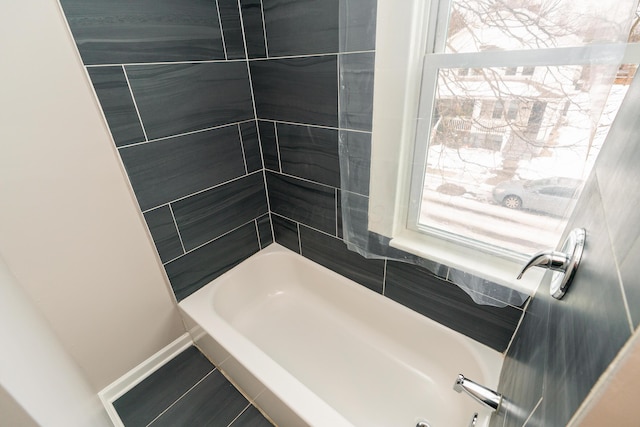 bathroom with tile patterned flooring and shower / bath combination