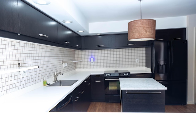 kitchen with sink, decorative light fixtures, decorative backsplash, a kitchen island, and black appliances