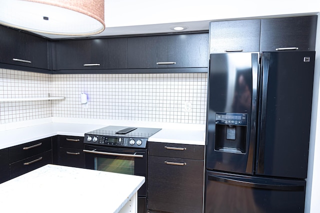 kitchen featuring black appliances and tasteful backsplash