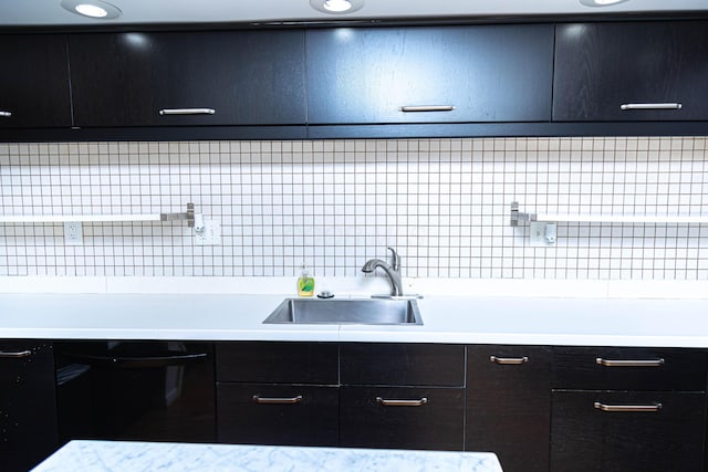 kitchen featuring sink, backsplash, and dishwasher