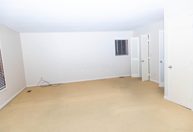 unfurnished room with light carpet