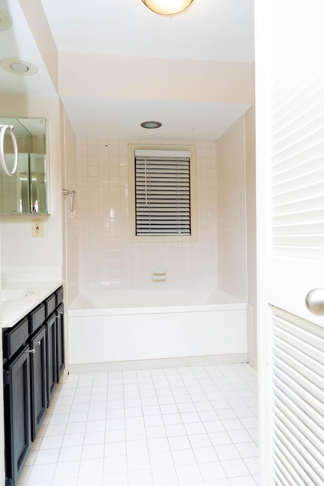 bathroom with vanity, tile patterned flooring, and tiled shower / bath combo