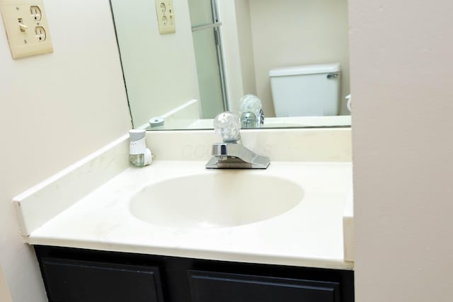 bathroom featuring vanity and toilet