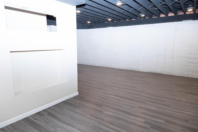 basement featuring dark hardwood / wood-style flooring