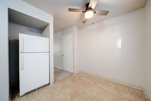 kitchen featuring ceiling fan and white fridge