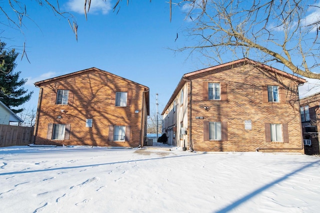 view of snow covered rear of property