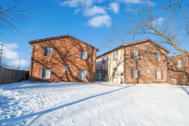 view of snow covered rear of property