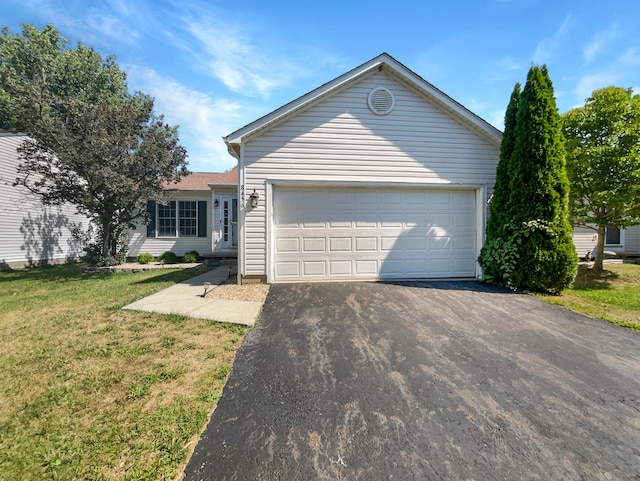 single story home featuring a front yard and a garage