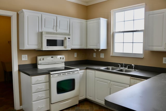 kitchen with sink, white appliances, white cabinetry, and crown molding