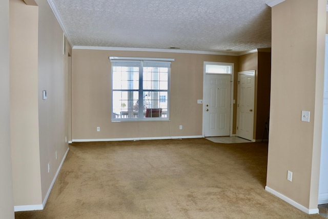 carpeted empty room featuring a textured ceiling and ornamental molding