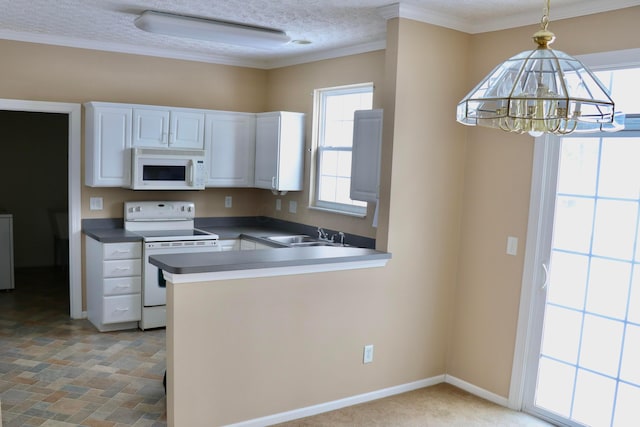 kitchen featuring white appliances, white cabinetry, sink, kitchen peninsula, and pendant lighting