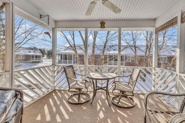 sunroom / solarium featuring ceiling fan