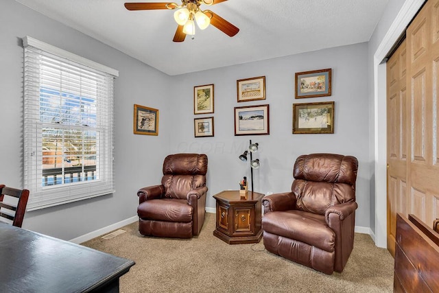 sitting room featuring carpet floors and ceiling fan