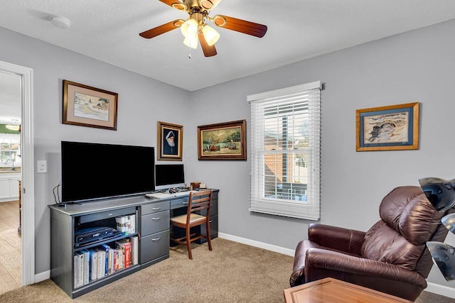 carpeted office featuring ceiling fan