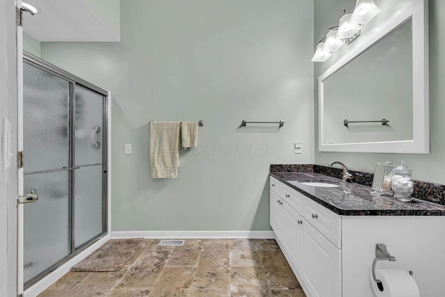 bathroom with walk in shower and vanity