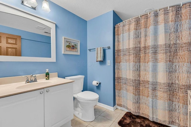 bathroom featuring toilet, vanity, tile patterned flooring, a shower with curtain, and a textured ceiling