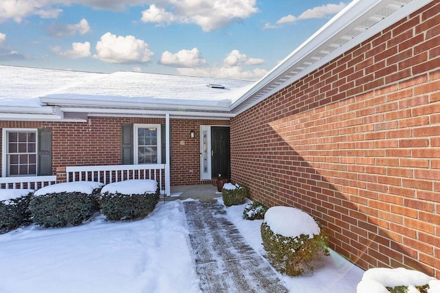 view of snow covered property entrance