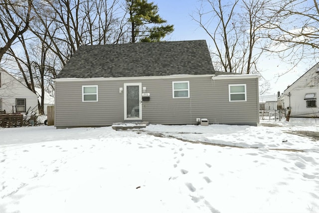 view of snow covered rear of property