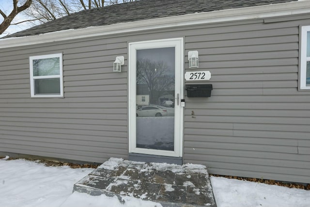 view of snow covered property entrance