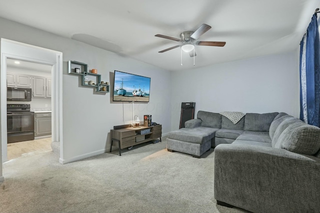 carpeted living room featuring ceiling fan