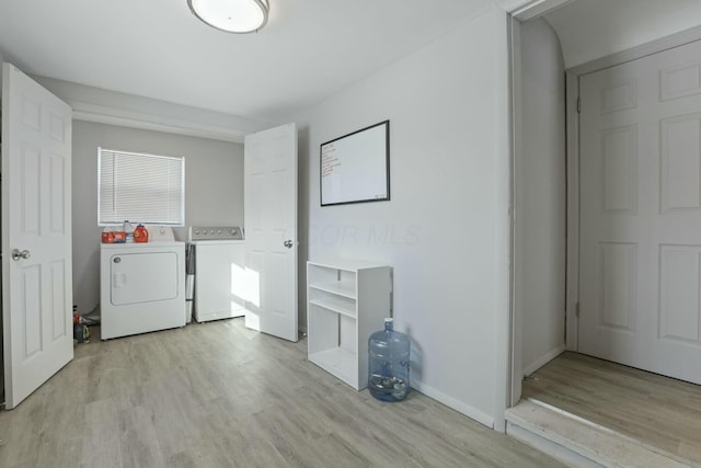 laundry area with light wood-type flooring and independent washer and dryer