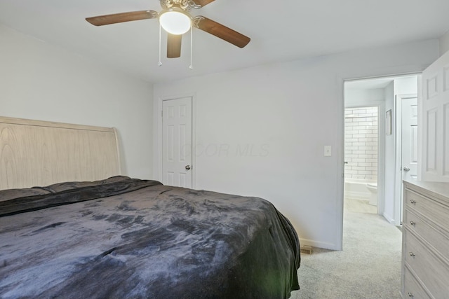 carpeted bedroom with ceiling fan and ensuite bath