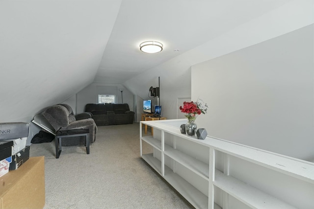 office space with light carpet and vaulted ceiling