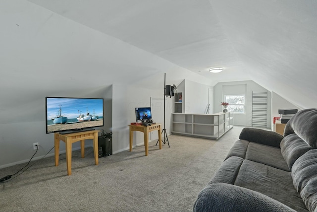 carpeted living room featuring vaulted ceiling