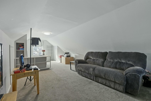 living room with built in shelves, vaulted ceiling, and carpet