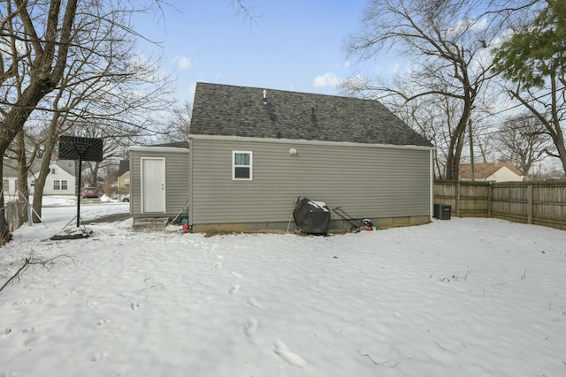 snow covered property featuring central AC