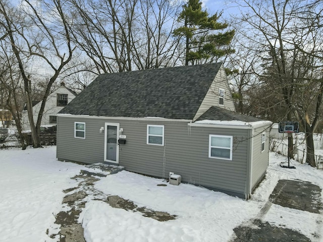 view of snow covered back of property