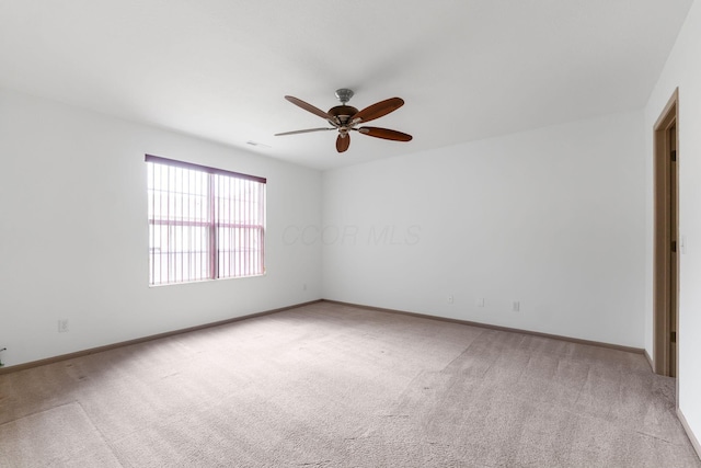 unfurnished room with ceiling fan and light colored carpet