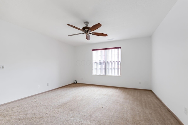 carpeted spare room with ceiling fan