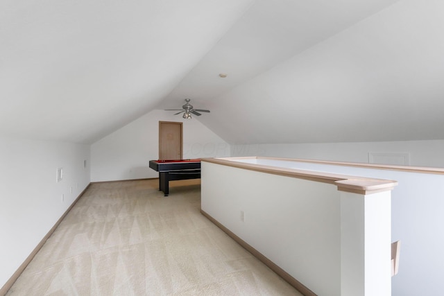 additional living space featuring light carpet and vaulted ceiling