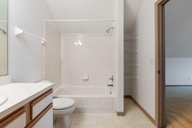 bathroom with bathtub / shower combination, toilet, vanity, baseboards, and tile patterned floors