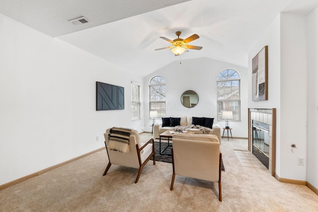 living room featuring light carpet, a fireplace, visible vents, and lofted ceiling