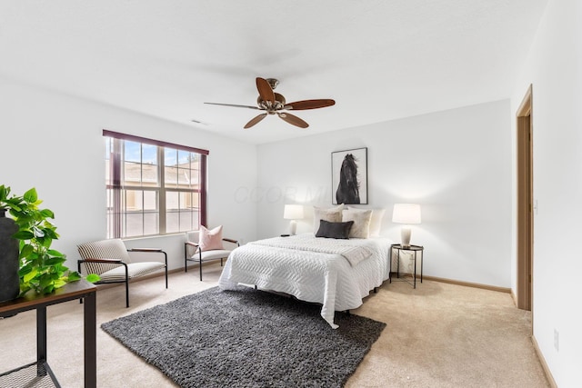 bedroom featuring light carpet, a ceiling fan, and baseboards