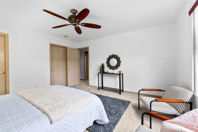 bedroom with carpet floors, a ceiling fan, and baseboards