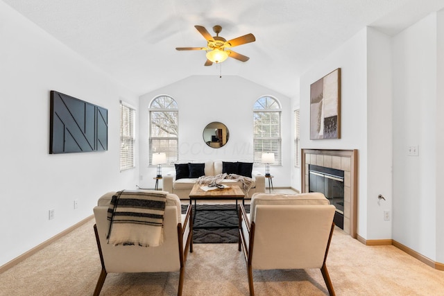 living room featuring baseboards, light carpet, vaulted ceiling, and a tiled fireplace