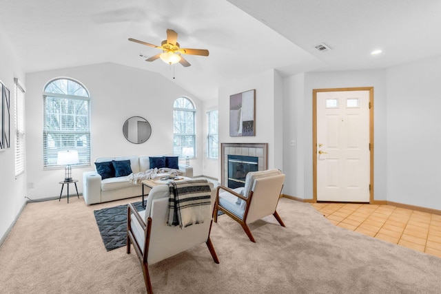 living room with a wealth of natural light, visible vents, and light colored carpet